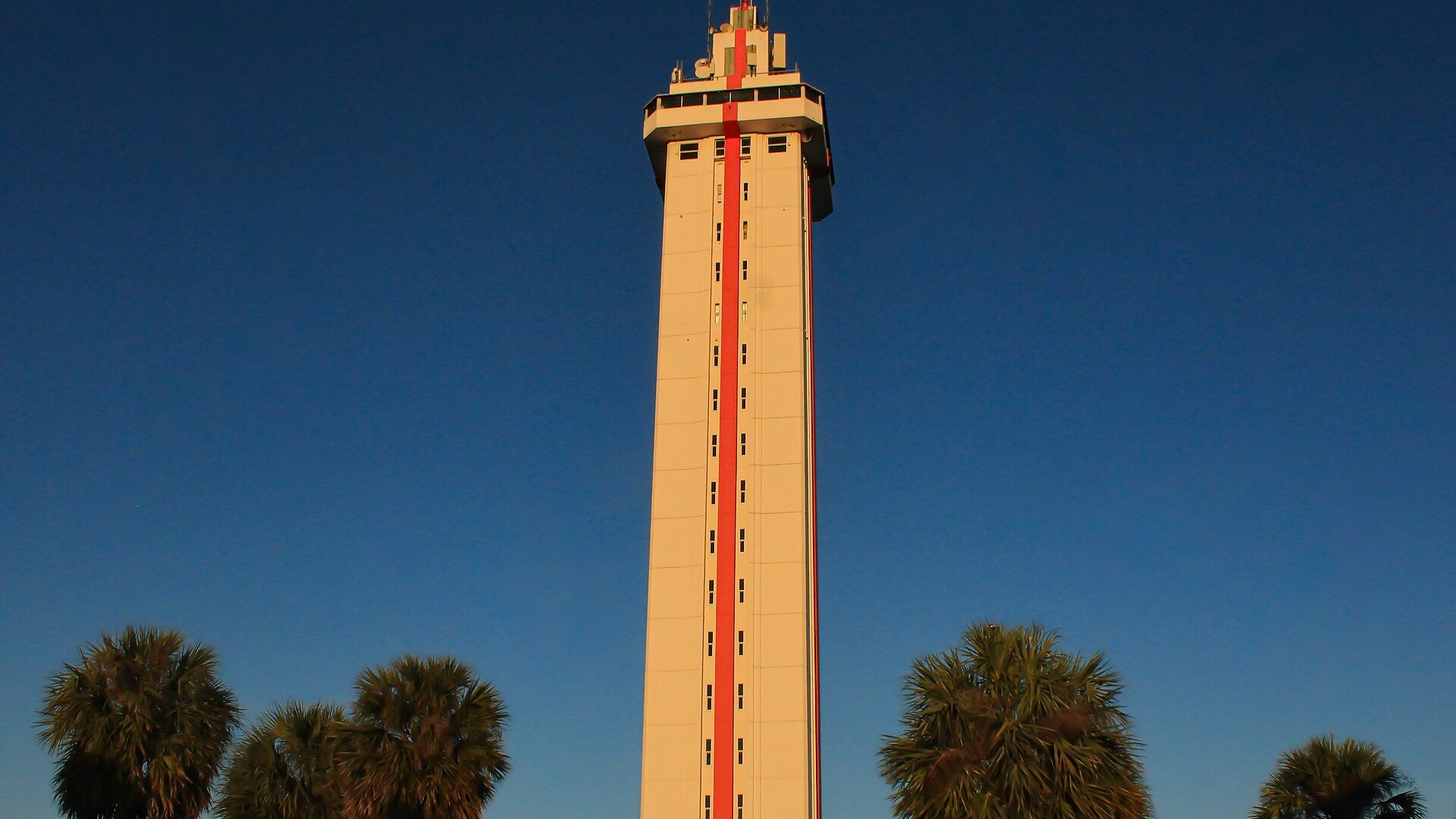 Florida Citrus Tower in Clermont lit by golden sunset light against a deep blue sky